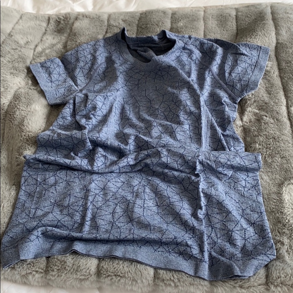 Blue geometric design athletic tee. Absorbant.